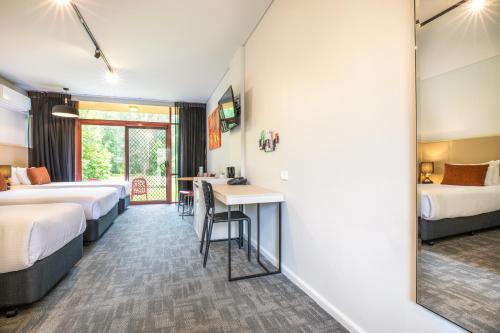 a hotel room with two beds and a desk at Nightcap at York on Lilydale in Mount Evelyn
