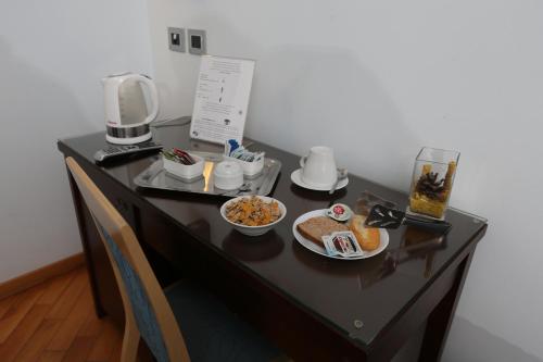a table with a breakfast of bread and cereal at Rigel Hotel in Catania