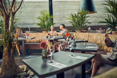 a group of people sitting at tables in a restaurant at Fort Resort Beemster in Zuidoostbeemster