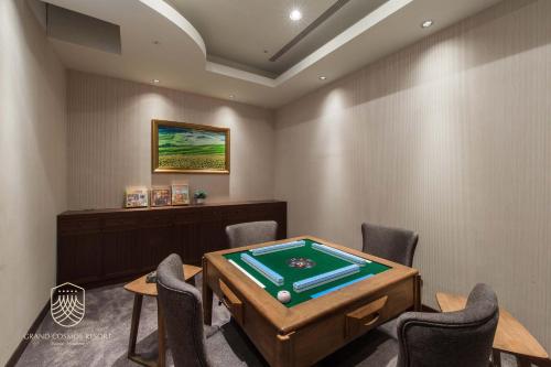 a game room with a pool table and chairs at Grand Cosmos Resort Ruisui Hualien in Ruisui