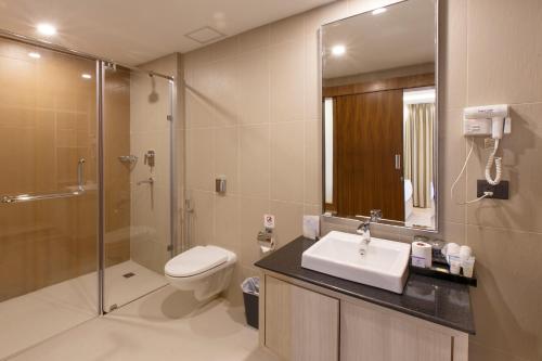 a bathroom with a toilet and a sink and a shower at Royal Singi Hotel in Kathmandu