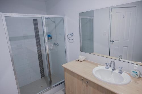 a bathroom with a glass shower and a sink at FortyTwo - Oceanside Retreat Busselton in Busselton