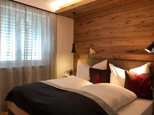 a bedroom with a large bed with a wooden wall at Am Holzmeisterweg 31 "Erika" in Gosau