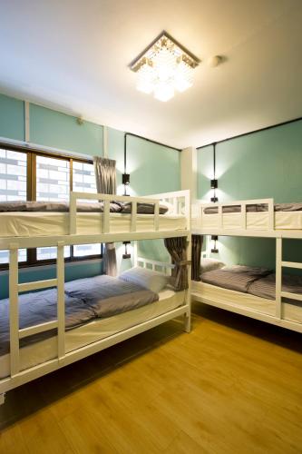 a room with three bunk beds in it at Hub Hostel Hatyai in Hat Yai