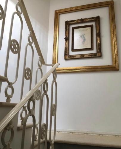 a picture frame on a wall next to a stairway at Masnadieri 18 in Parma