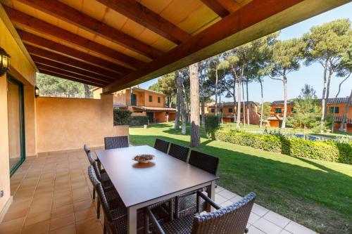 a patio with a table and chairs on a porch at Casas Golf Relax in Pals
