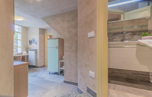 a kitchen with a sink and a refrigerator at Del Duca Apartment in Varenna