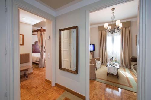 a hallway of a living room with a mirror at Parador de Teruel in Teruel