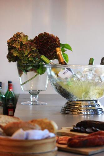 a table with a vase of flowers and a bowl of food at Amoras Country House Hotel in Proença-a-Nova