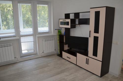 a living room with a flat screen tv on a entertainment center at Апартаменты на Фадеева in Tver