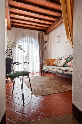 a room with a couch and a chair in a room at Romitorio di Serelle in Barberino di Val dʼElsa