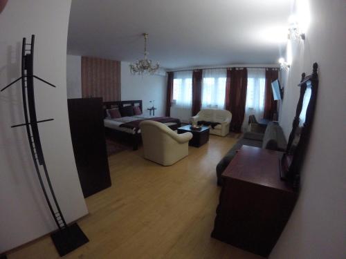 a view of a living room with a couch and a bed at Dózsaház in Zalaegerszeg