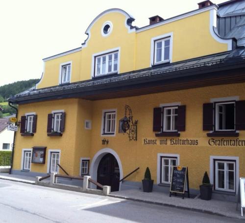 a yellow building with a sign in front of it at KU:L Apartment 4pers. Planai Dachstein in Öblarn