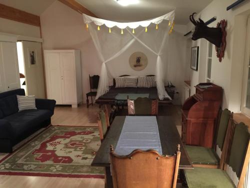 a living room with a table and a bed with a tent at KU:L Apartment 4pers. Planai Dachstein in Öblarn