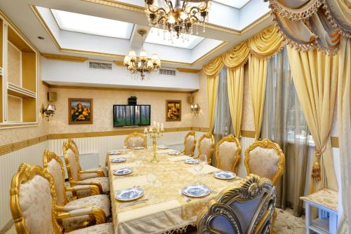 a dining room with a table and chairs and a chandelier at Hotel Boyana - Free Parking in Sofia