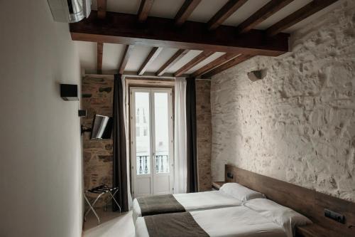 Säng eller sängar i ett rum på Via Aetcal Hotel & Wellness