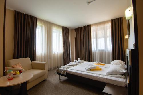 a hotel room with two beds and a television at Park Hotel Arbanassi in Arbanasi