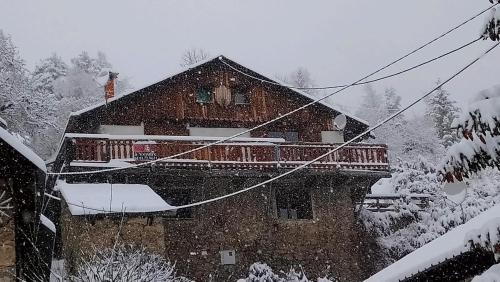 a house covered in snow in front at Sur Un Petit Nuage in Roubion