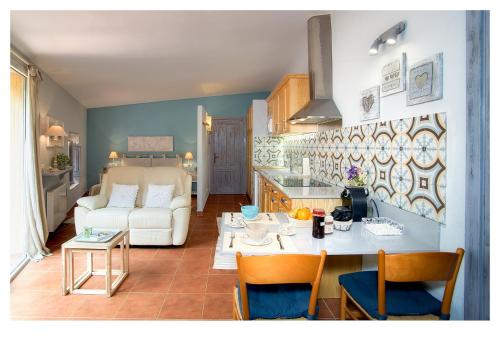 a kitchen and living room with a couch and a table at Can Pitu Ferriol in Montrás
