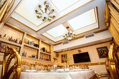 a dining room with a table and a tv at Hotel Boyana - Free Parking in Sofia