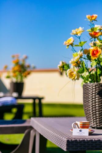 a table with a vase with flowers on it at Culture Residence Consalvo Otto in Naples