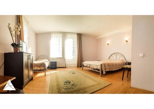 Postel nebo postele na pokoji v ubytování My House in Bakuriani