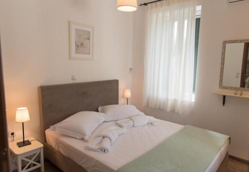 a bedroom with a bed with towels on it at Villa Iliogioma with private pool and sea view in Katomérion