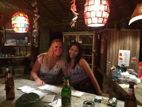 two women sitting at a counter in a bar at Freedom home in Ko Chang