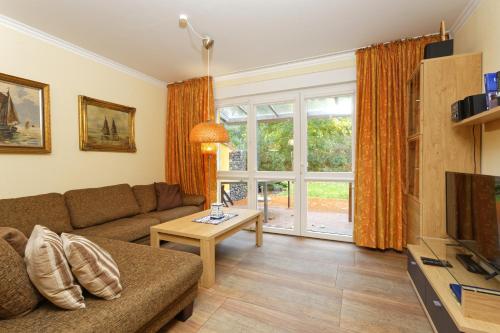 a living room with a couch and a table at Ostseepark Zempin in Zempin