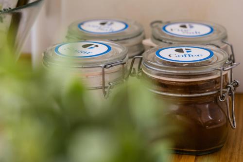 three jars of honey sitting on a table at Culture Residence Consalvo Otto in Naples
