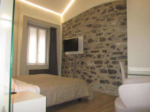 En eller flere senger på et rom på Hotel Borgovico