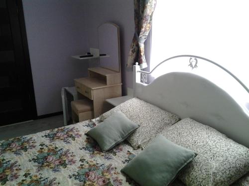 a bedroom with a bed with two pillows on it at Villa Galicia in Berehove