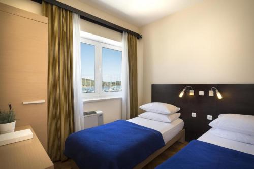 Ein Bett oder Betten in einem Zimmer der Unterkunft Apartment ACI Marina CRES