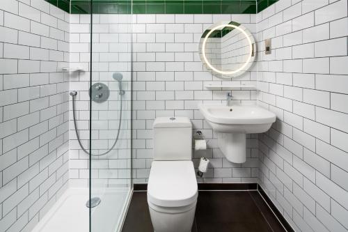 a bathroom with a toilet and a sink and a mirror at ibis Styles London Gloucester Road in London