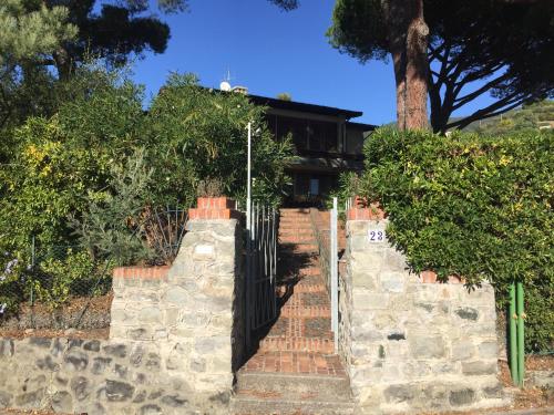 a gate in front of a house with trees at Il nido della gazza in Monterosso al Mare