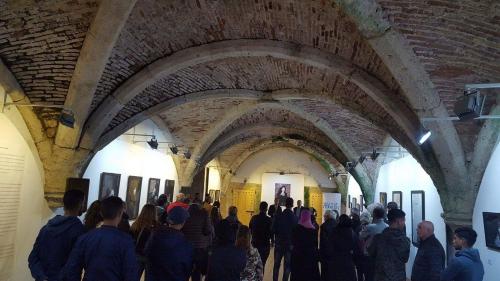 a crowd of people looking at paintings in a building at Art studio au bord de la mer in El Jadida