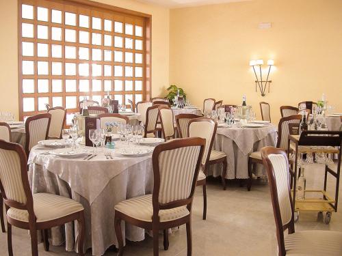 a dining room with tables and chairs and a window at Hotel L' Anicrè in Marina di Varcaturo