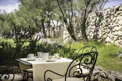 a table with chairs and a white table cloth on it at Apartment ACI Marina CRES in Cres