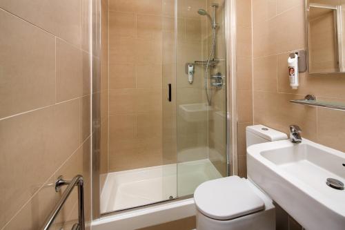 a bathroom with a shower and a toilet and a sink at ibis Styles London Gloucester Road in London