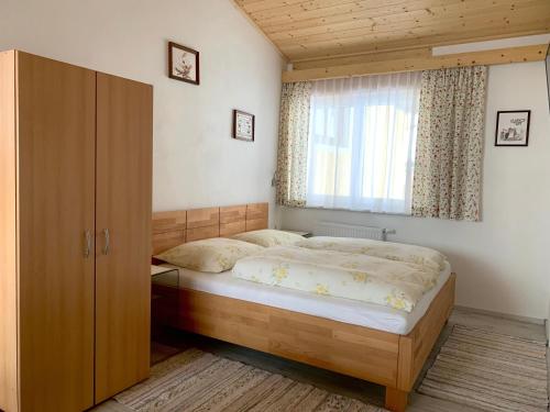 a bedroom with a bed and a window at Bergblick in Wagrain