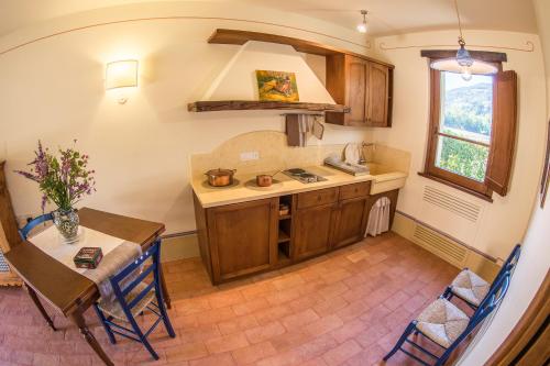 a small kitchen with a table and a sink at Vocabolo Monache in Ponte Pattoli