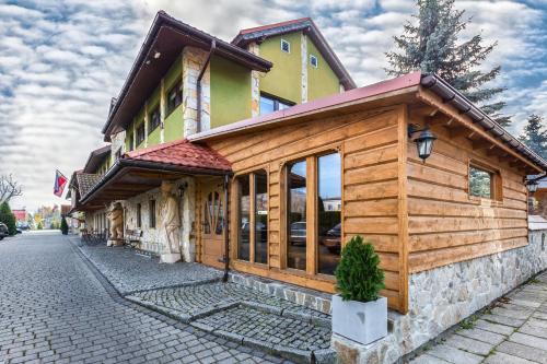 a wooden building on the side of a street at Zajazd Beskidy in Żywiec