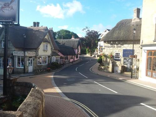 an empty street in a small town with buildings at Chine Side in Shanklin