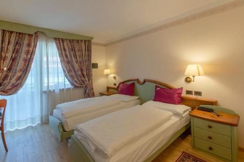 Cama o camas de una habitación en Albergo Alla Rosa