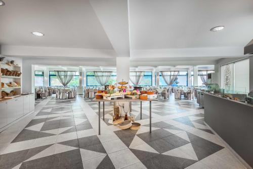 a dining room with a table and chairs at Atrium Hotel in Pefkohori