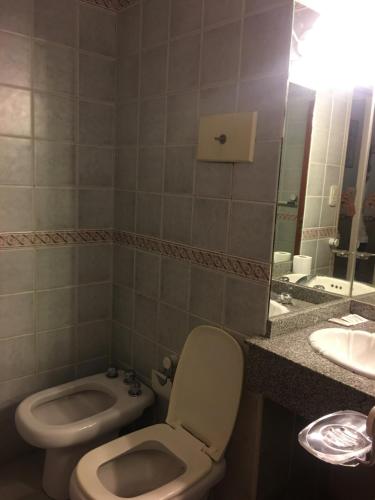 a bathroom with a toilet and a sink at Hotel Rey in Buenos Aires
