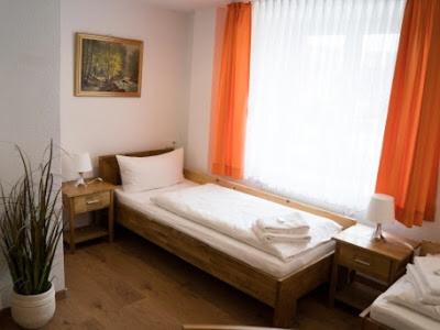 a small bed in a room with a window at Landgasthof Ochsen in Wutöschingen