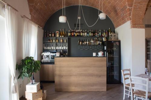 a bar with a wooden counter in a room at Fattoria L'Olmetto in Pisa