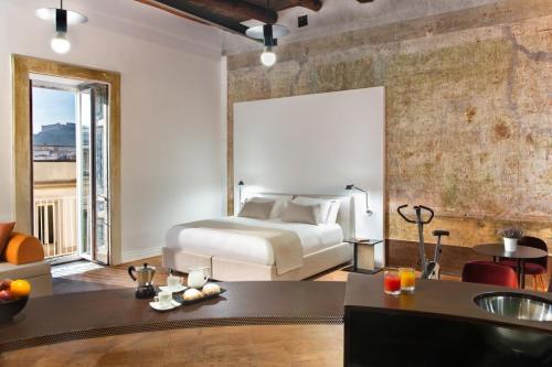 a bedroom with a bed and a living room at Artemisia Domus - Centro Storico in Naples
