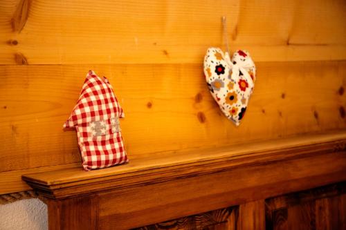 two umbrellas are hanging on a wooden wall at Zagroda Krasna in Polańczyk